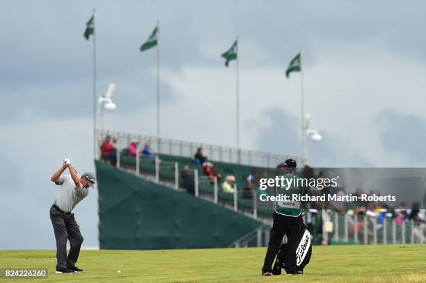 Woody Austin of the United States hits his second shot on the 18th hole during the third round of the Senior Open Championship presented by Rolex at...