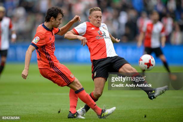 Ruben Pardo from Real Sociedad is tackled by Jens Toornstra from Feyenoord during the friendly match between Feyenoord and Real Sociedad at De Kuip...