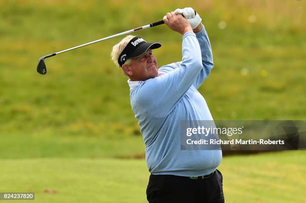 Colin Montgomerie of Scotland hits his second shot on the 2nd hole during the third round of the Senior Open Championship presented by Rolex at Royal...