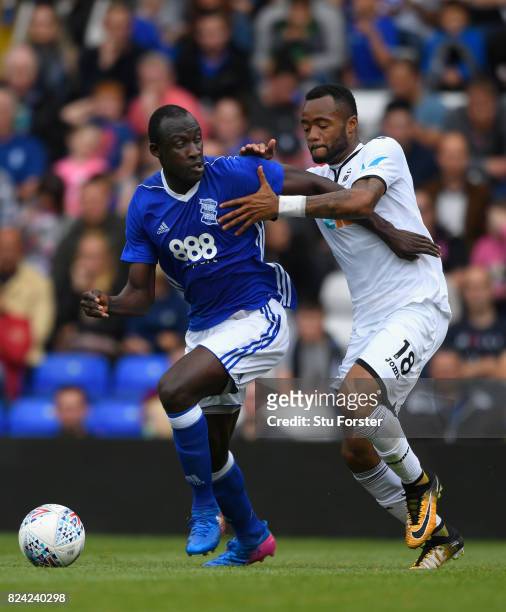 Swansea player Jordan Ayew challenges Cheikh Ndoye of Birmingham during the Pre Season Friendly match between Birmingham City and Swansea City at St...