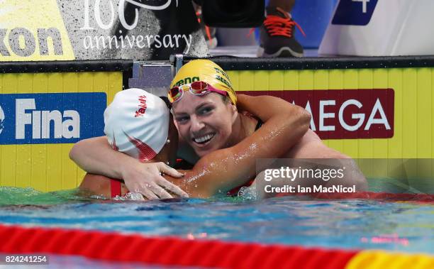 Emily Seebohm of Australia reacts with Kylie Masse of Canada after wining the Women's 200m Backstroke final during the FINA World Championships at...