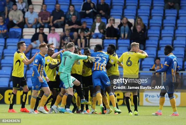 Players from both sides scuffle after Marvin Sordell of Burton Albion challenged Abu Ogogo of Shrewsbury Town during the Pre- Season Friendly between...