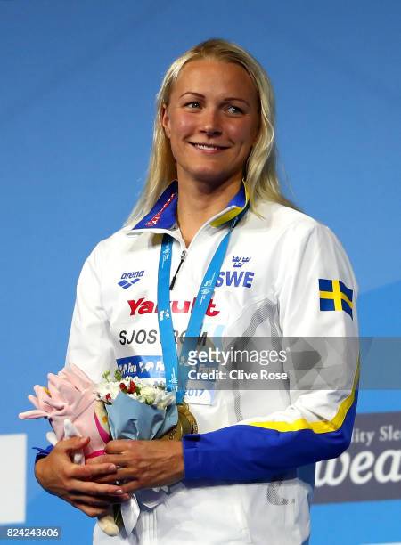 Gold medalist Sarah Sjostrom of Sweden poses with the medal won during the Women's 50m Butterfly final on day sixteen of the Budapest 2017 FINA World...