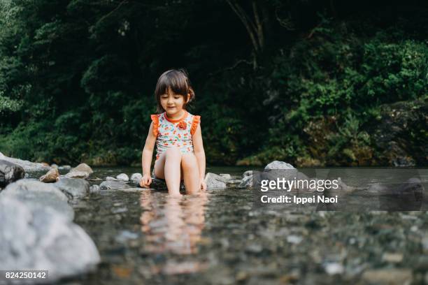 Toddler girl playing in river, Okutama, Tokyo