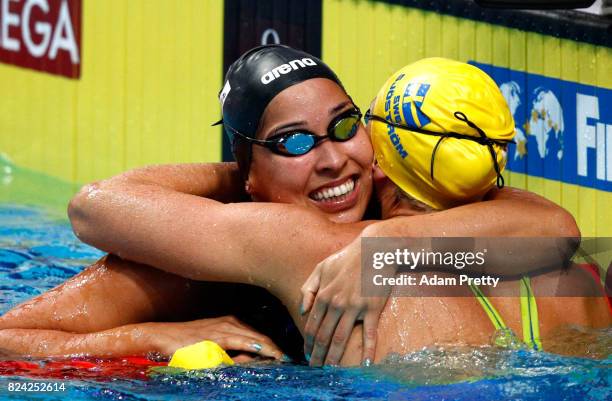 Sarah Sjostrom of Sweden is congratulated by Ranomi Kromowidjojo of the Netherlands after setting a new world record time of 26.67 during the Women's...