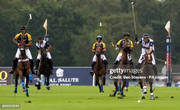 England, in white, and Commonwealth polo players during the Royal Salute Coronation Cup polo at Windsor Great Park in Surrey.