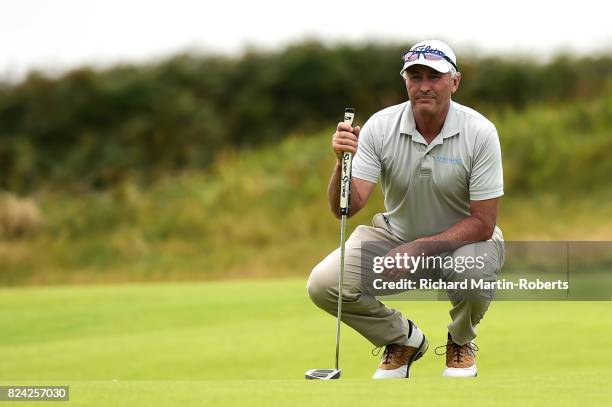David Mckenzie of Australia lines up a putt on the 2nd green during the third round of the Senior Open Championship presented by Rolex at Royal...