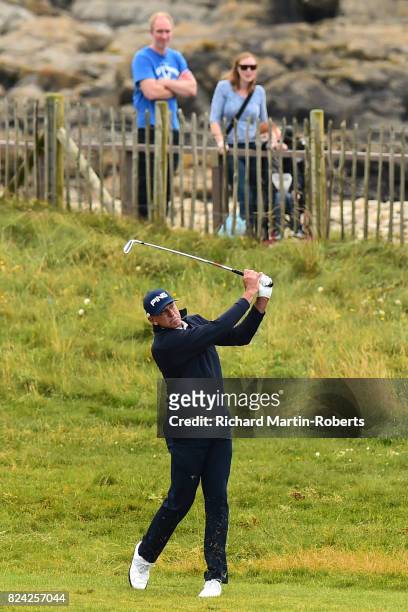 Peter Fowler of Australia hits his second shot on the 2nd hole during the third round of the Senior Open Championship presented by Rolex at Royal...