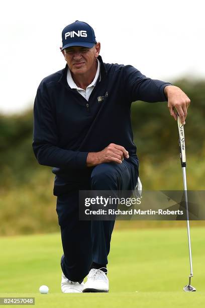 Peter Fowler of Australia lines up a putt on the 2nd green during the third round of the Senior Open Championship presented by Rolex at Royal...