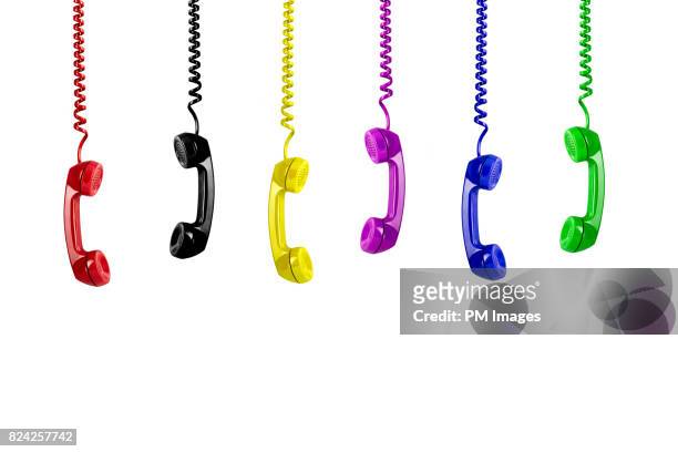 multi colored telephone receivers hanging down - telefonlur bildbanksfoton och bilder