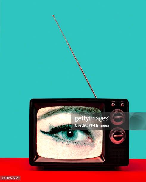 woman's eye on vintage tv - vertical tv stock pictures, royalty-free photos & images