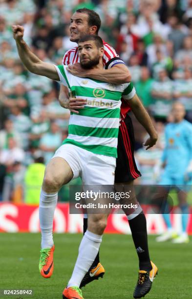 Nadir Ciftci of Celtic tangles with John O'Shea of Sunderland during a pre-season friendly match between Sunderland AFC and Celtic at the Stadium of...