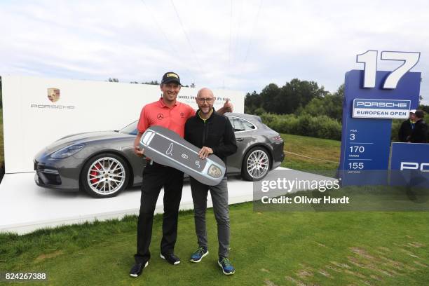 Marcel Siem of Germany and Oliver Eidam , Director of Brands Partnerships and Sponsoring at the Porsche AG receive his price at Porsche Panamera...