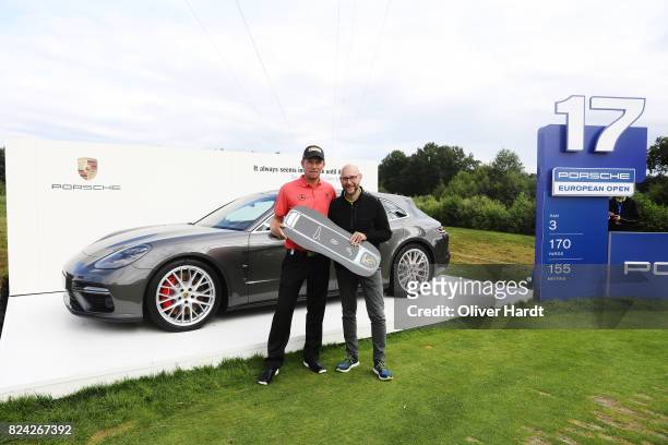 Marcel Siem of Germany and Oliver Eidam , Director of Brands Partnerships and Sponsoring at the Porsche AG receive his price at Porsche Panamera...