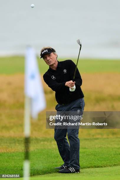 Bernhard Langer of Germany chips to the 18th green during the third round of the Senior Open Championship presented by Rolex at Royal Porthcawl Golf...