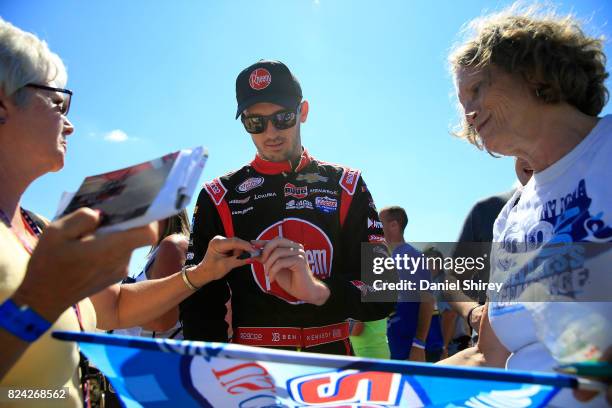 Ben Kennedy, driver of the RTP/Rheem Chevrolet, signs autographs during qualifying for the NASCAR XFINITY Series US Cellular 250 Presented by...