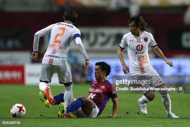 Masatoshi Mihara of Vissel Kobe controls the ball under pressure of Kosuke Kikuchi and Takuya Wada of Omiya Ardija during the J.League J1 match...