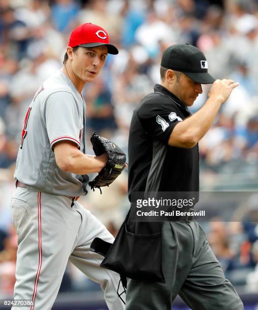 Pitcher Homer Bailey of the Cincinnati Reds talks with umpire Mark Wegner in an interleague MLB baseball game against the New York Yankees on July...