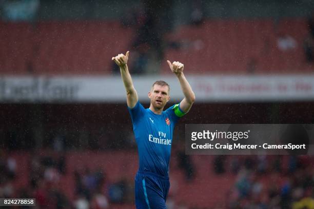 Arsenal's Per Mertesacker applauds the fans at the final whistle during the Emirates Cup match between Arsenal and SL Benfica at Emirates Stadium on...