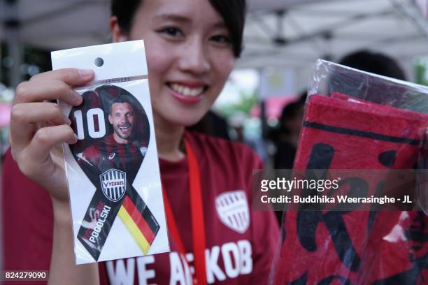 Vissel Kobe official marchandise shop staffs show Lukas Podolski goods prior to the J.League J1 match between Vissel Kobe and Omiya Ardija at Noevir...