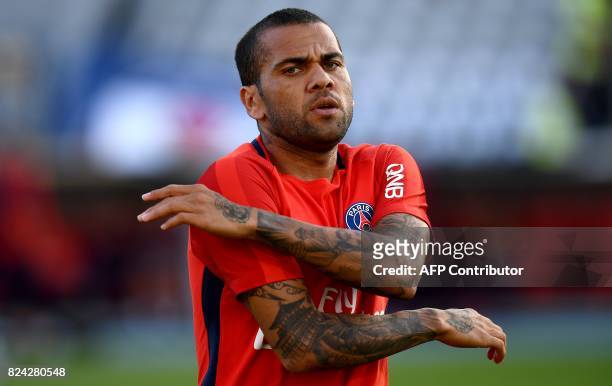 Paris Saint-Germain's Brazilian defender Dani Alves warms up ahead of the French Trophy of Champions football match between Monaco and Paris...