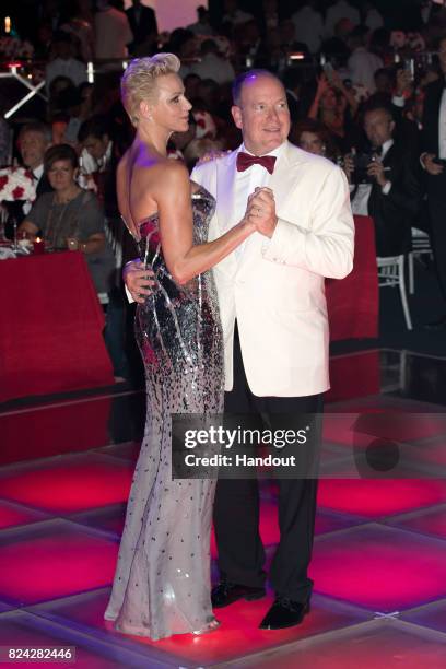 Princess Charlene of Monaco and Prince Albert II of Monaco dance at the 69th Monaco Red Cross Ball Gala at Sporting Monte-Carlo on July 28, 2017 in...