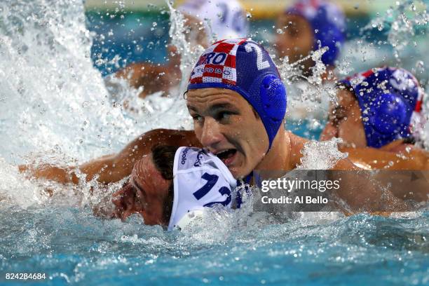 Marko Macan of Croatia and Balazs Harai of Hungary clash during the Men's Waterpolo Final between Hungary and Croatia on day sixteen of the Budapest...