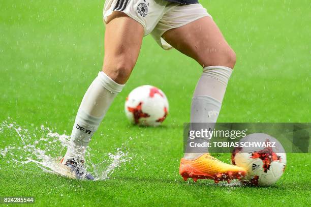 German player warms up under the rain prior to the start of the UEFA Womens Euro 2017 football quarter-finals match between Germany and Denmark at...