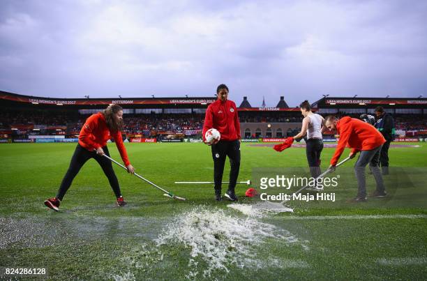 Steffi Jones, head coach of Germany walks on the pitch as groundsmen remove water after heavy rain prior to the UEFA Women's Euro 2017 Quarter Final...