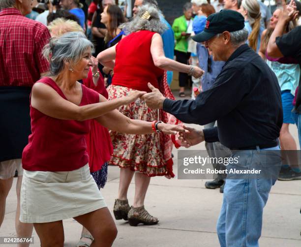 Couple dances during a live music concert in the historic Plaza in Santa Fe, New Mexico.