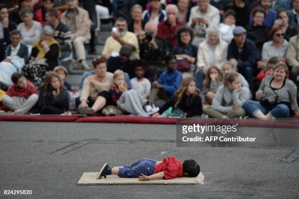 Model representing the dead Syrian refugee child Aylan Kurdi is pictured during the show called "miniatures" of the French mechanical marionette...