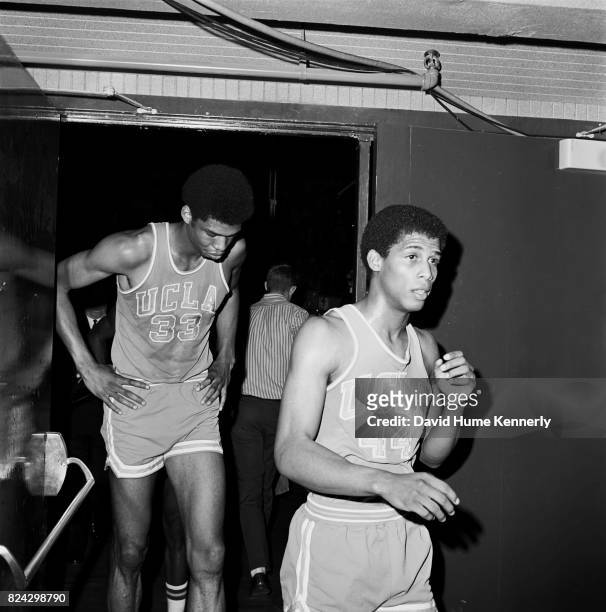 Lew Alcindor Jr and Michael Warren leave the court after a UCLA vs Oregon basketball game, Oregon, 1966.