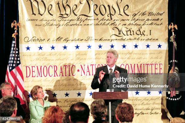President Bill Clinton delivers a speech at the Democratic Business Leaders event, Washington DC, September 10, 1998. First Lady Hillary Clinton sits...