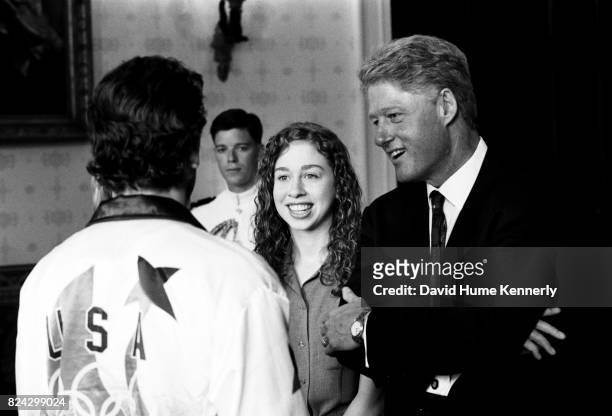 Chelsea Clinton and President Bill Clinton greet a member of the US Olympic Team during a reception at the White House, Washington DC, August 7, 1996.