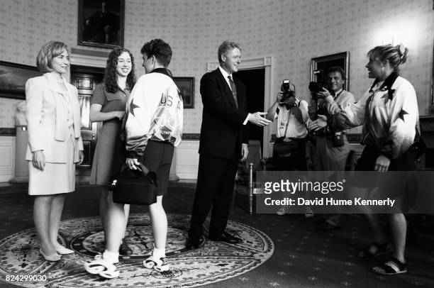 First Lady Hillary Clinton, daughter Chelsea and President Bill Clinton greet members of the US Olympic Team during a reception at the White House,...