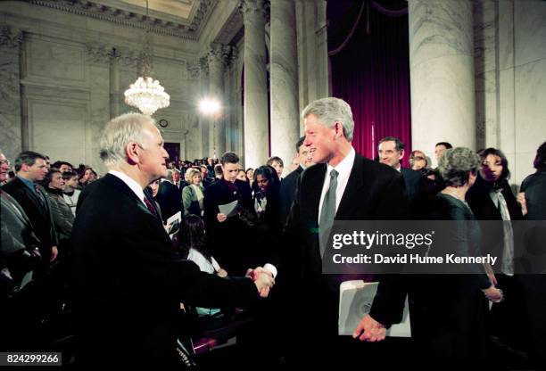 President Bill Clinton greets former Senator Bob Packwood at a memorial service in the White House, Washington DC, January 28, 1999. The service was...