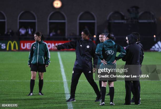 Steffi Jones, head coach of Germany talks with match officials shortly before the game was postponed due to heavy rain prior to the UEFA Women's Euro...
