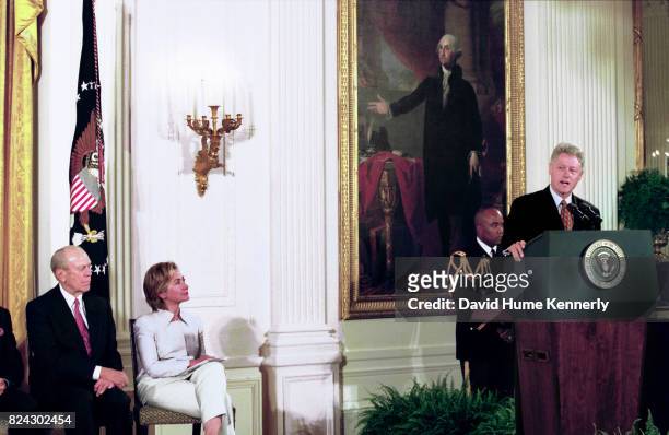 Former President Gerald Ford, and First Lady Hillary Clinton listen to President Bill Clinton speaking at the award ceremony in the East Room of the...