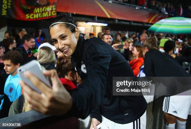 Sara Doorsoun-Khajeh of Germany takes a selfie with fans after the game was postponed due to heavy rain prior to the UEFA Women's Euro 2017 Quarter...