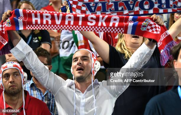 Croatian fans cheer for their team's gold medal in the 'Hajos Alfred' swimming pool of Budapest on July 29, 2017 after the men final of FINA2017...