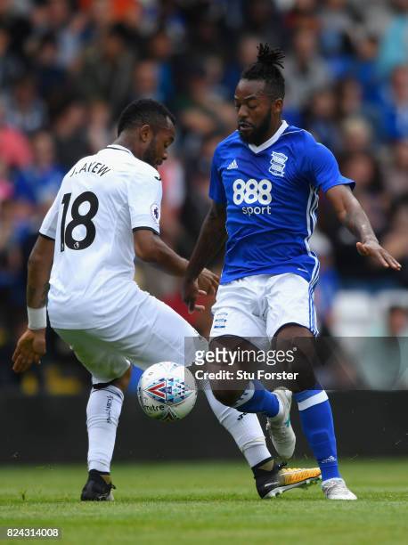 Swansea player Jordan Ayew is challenged by Jacques Maghoma of Birmingham during the Pre Season Friendly match between Birmingham City and Swansea...
