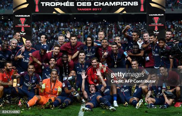 Paris Saint-Germain's players pose with the trophy as they celebrate winning the French Trophy of Champions football match between Monaco and Paris...