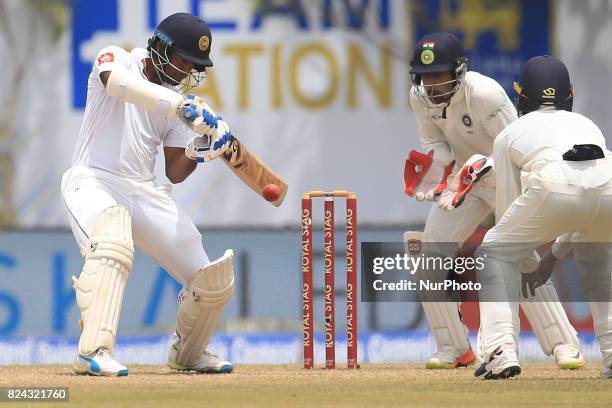 Sri Lankan cricketer Dimuth Karunaratne plays a shot during the 4th Day's play in the 1st Test match between Sri Lanka and India at the Galle cricket...