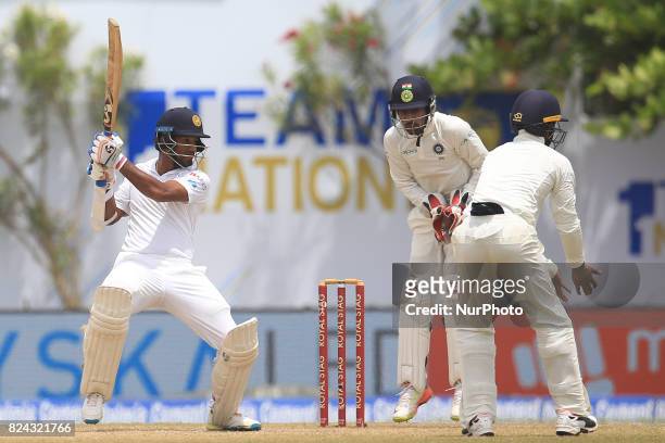 Sri Lankan cricketer Dimuth Karunaratne plays a shot during the 4th Day's play in the 1st Test match between Sri Lanka and India at the Galle cricket...