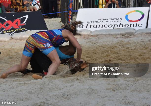 Romania's Linquararu Madalina wrestles against Senegalese Binette Diata in the individual combat 50kg Traditional Wrestling Woman's bout during the...