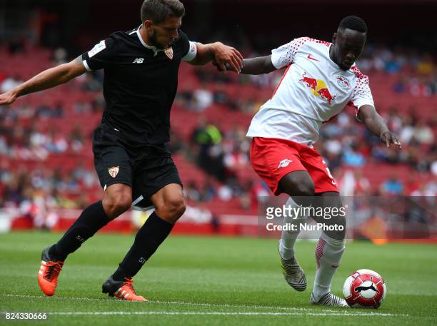 Jean-Kevin Augustin of RB Leipzig holds of Daniel Carrico of Sevilla FC during Emirates Cup match between RB Leipzig against Sevilla at Emirates...