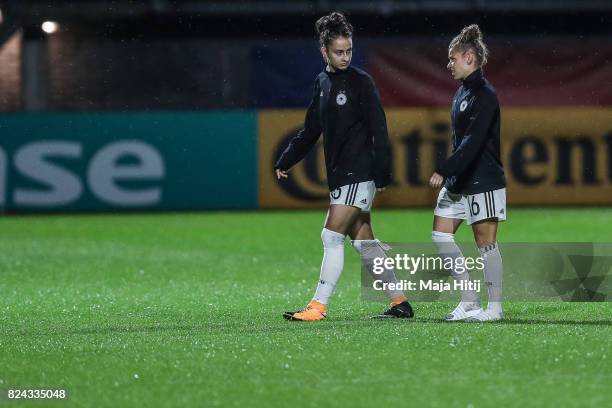 Sara Daebritz of Germany and Linda Dallmann leave the pitch after the game was postponed due to heavy rain prior to the UEFA Women's Euro 2017...