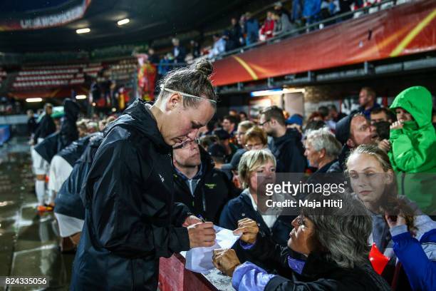 Kristin Demann of Germany gives autographs to the fans after the game was postponed due to heavy rain prior to the UEFA Women's Euro 2017 Quarter...