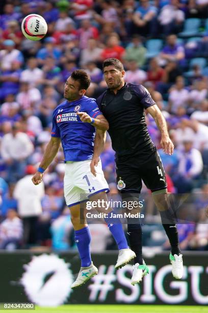 Martin Cauteruccio of Cruz Azul jumps for the ball with Jair Pereira of Chivas, during the 2nd round match between Cruz Azul and Chivas as part of...