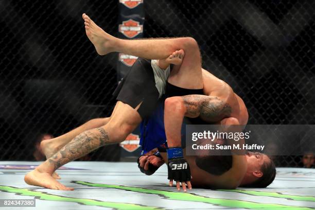 Renato Moicano of Brazil is defeated by Brian Ortega during their Featherweight bout at UFC 214 at Honda Center on July 29, 2017 in Anaheim,...